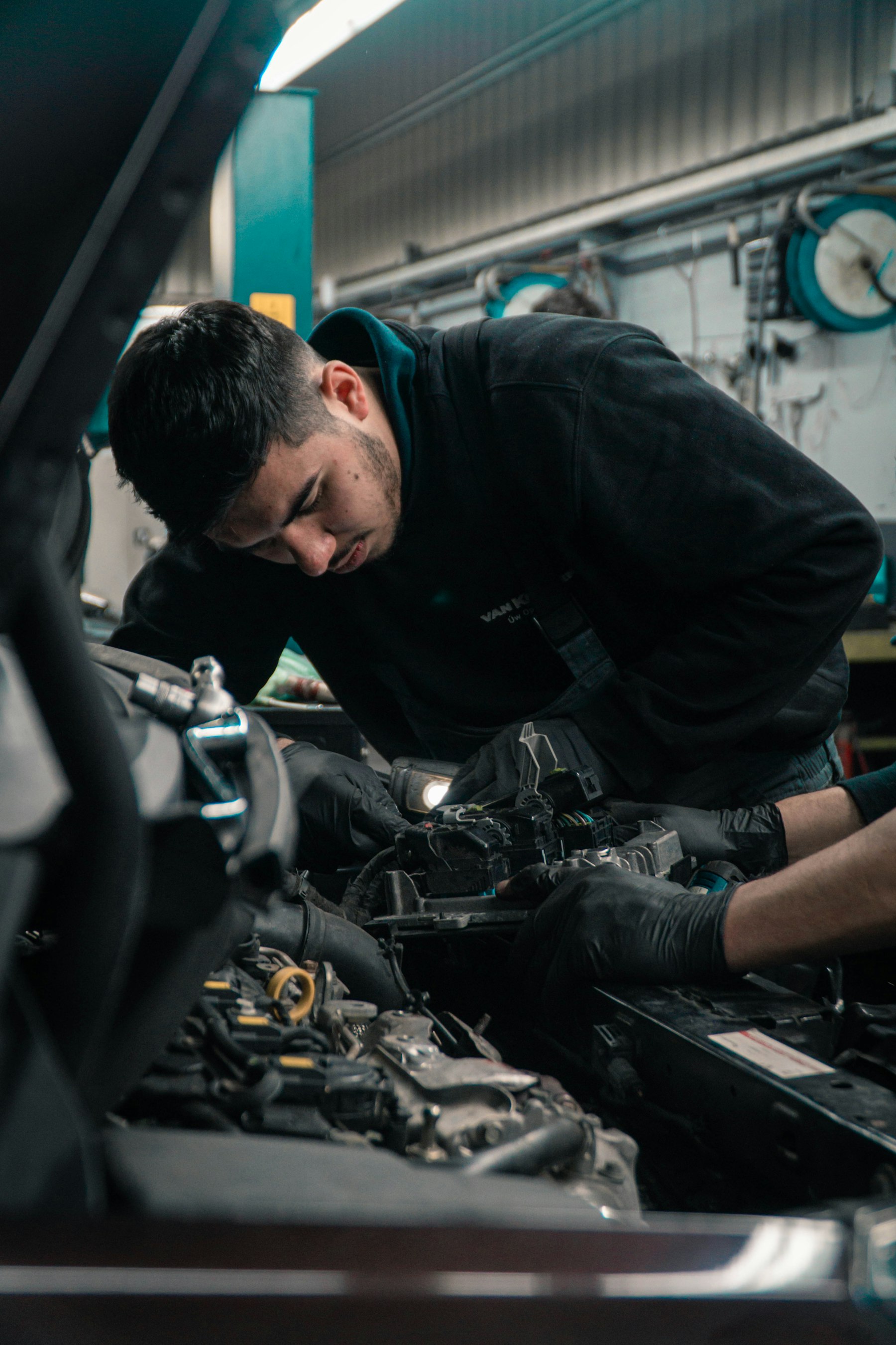 A mechanic working on a car engine in a garage