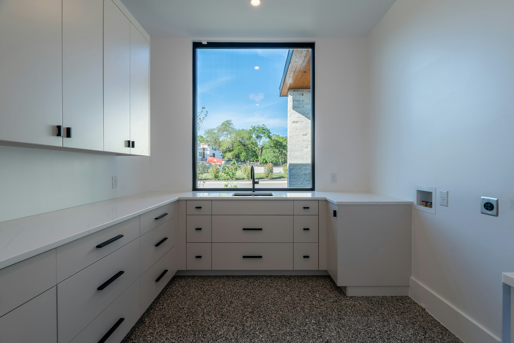 A white kitchen countertop with matching cabinets and drawers