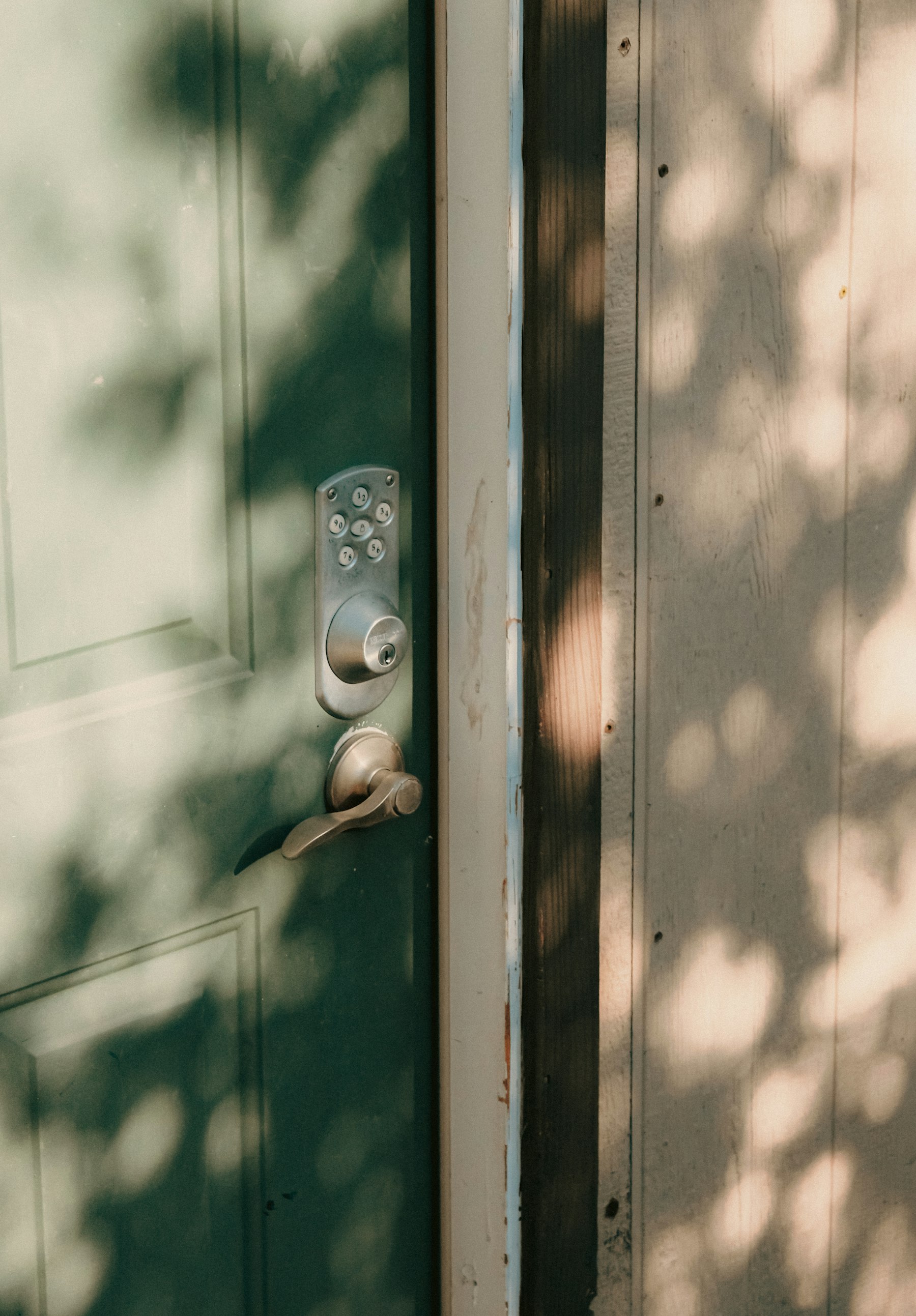 An electronic keypad deadbolt lock on a residential front door