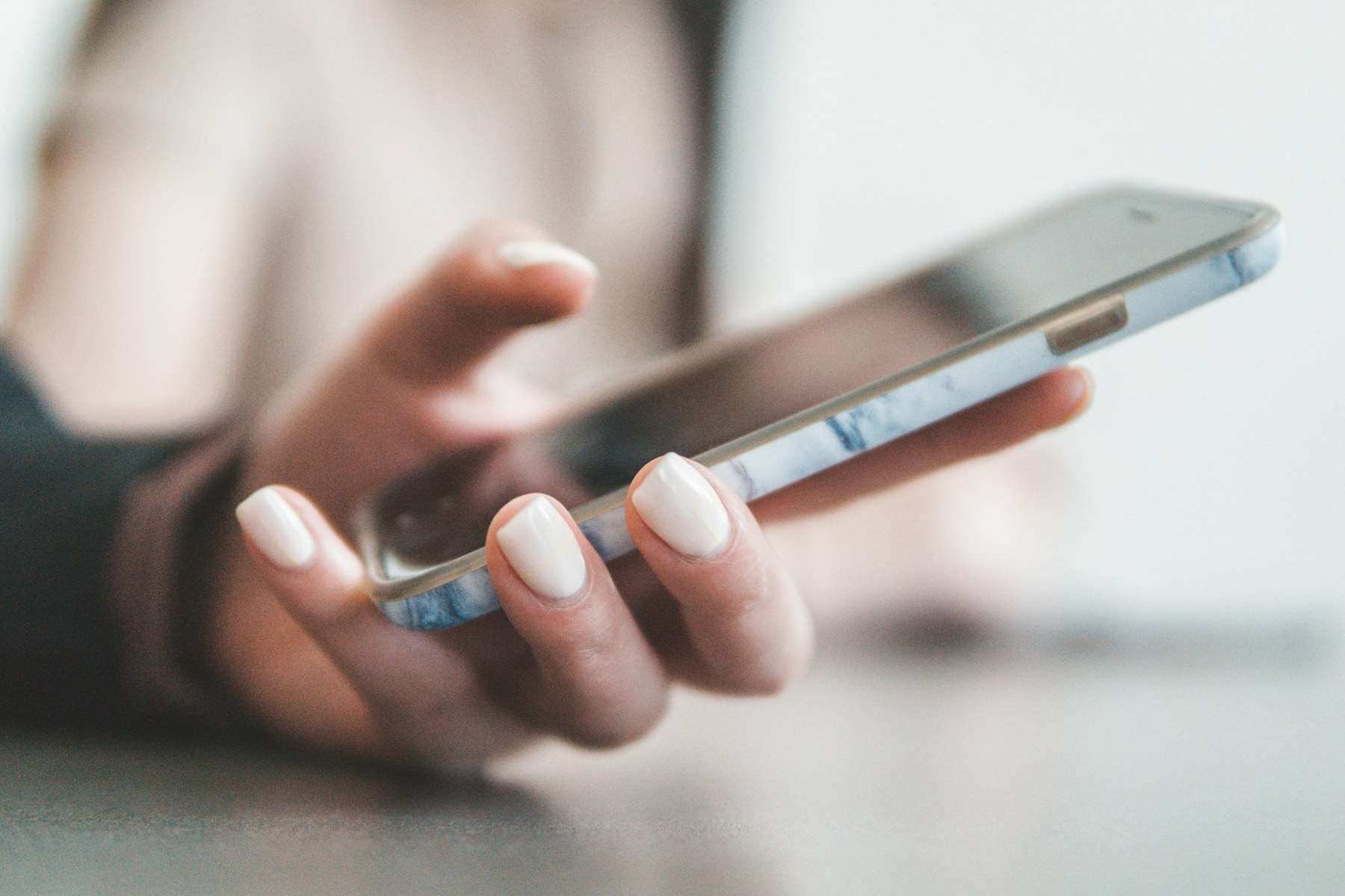 A hand holding a smartphone