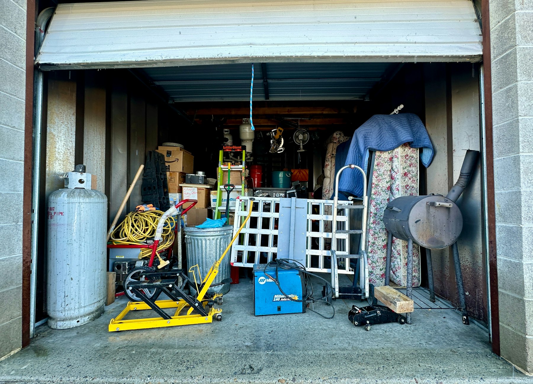 A garage filled with clutter and old items ready for removal