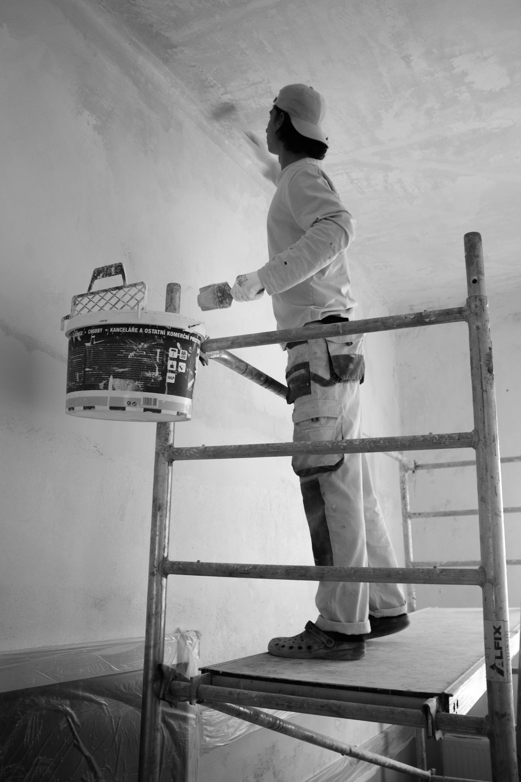 A painter rolling fresh paint onto an interior wall