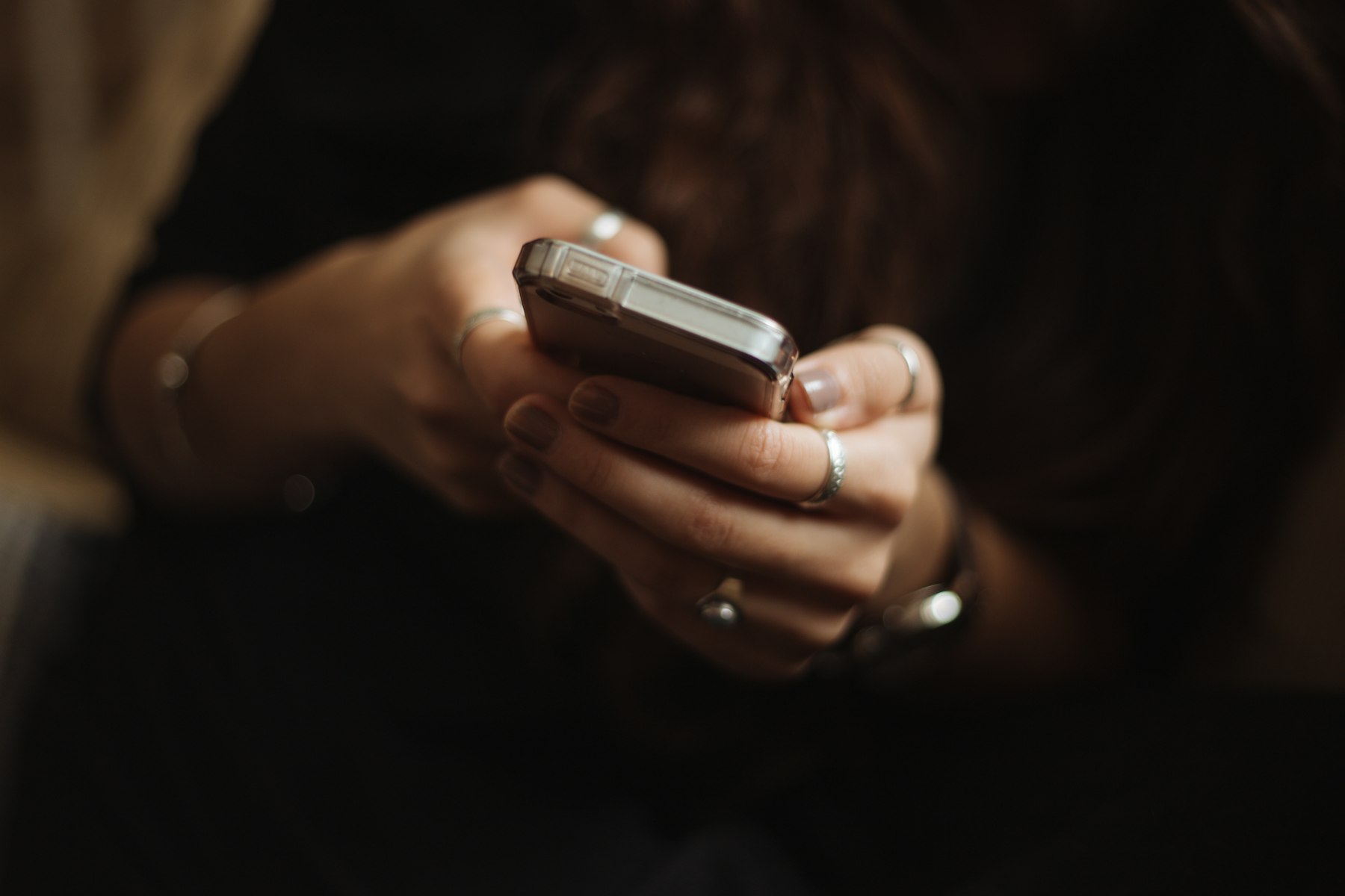 Close-up of hands holding a smartphone to send a text message