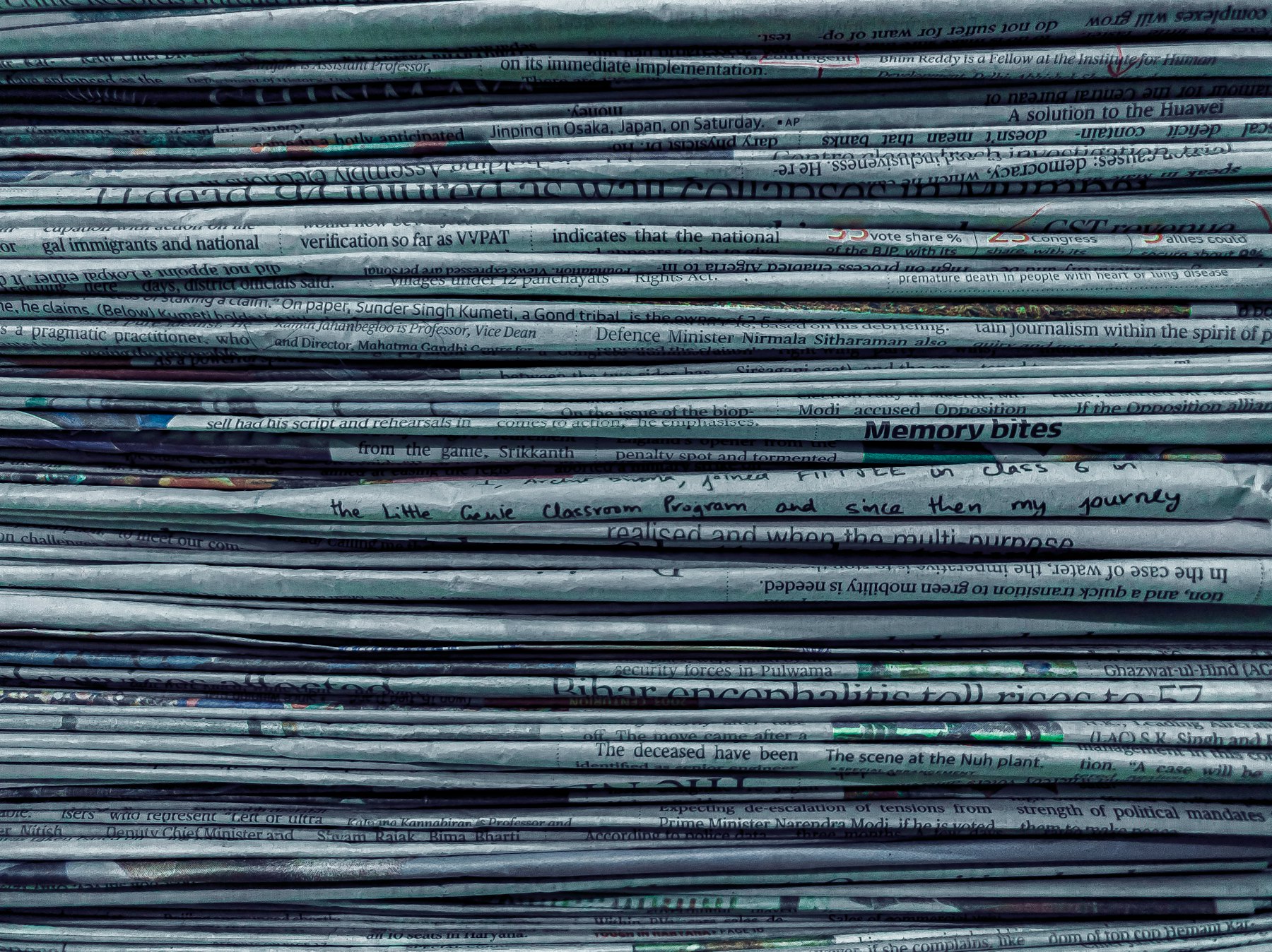 A stack of identical newspapers viewed edge-on
