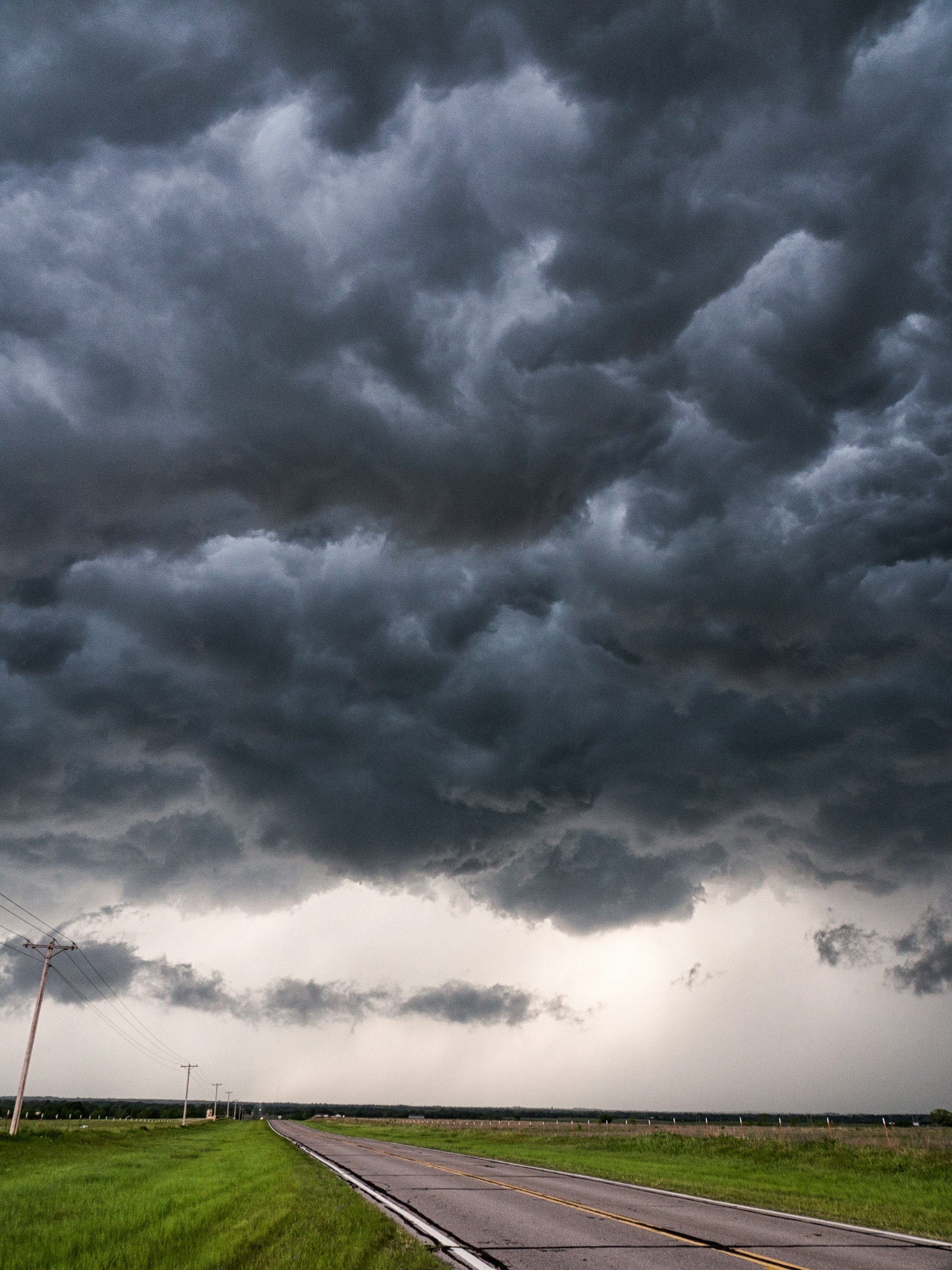 Dark storm clouds over a rural Oklahoma road