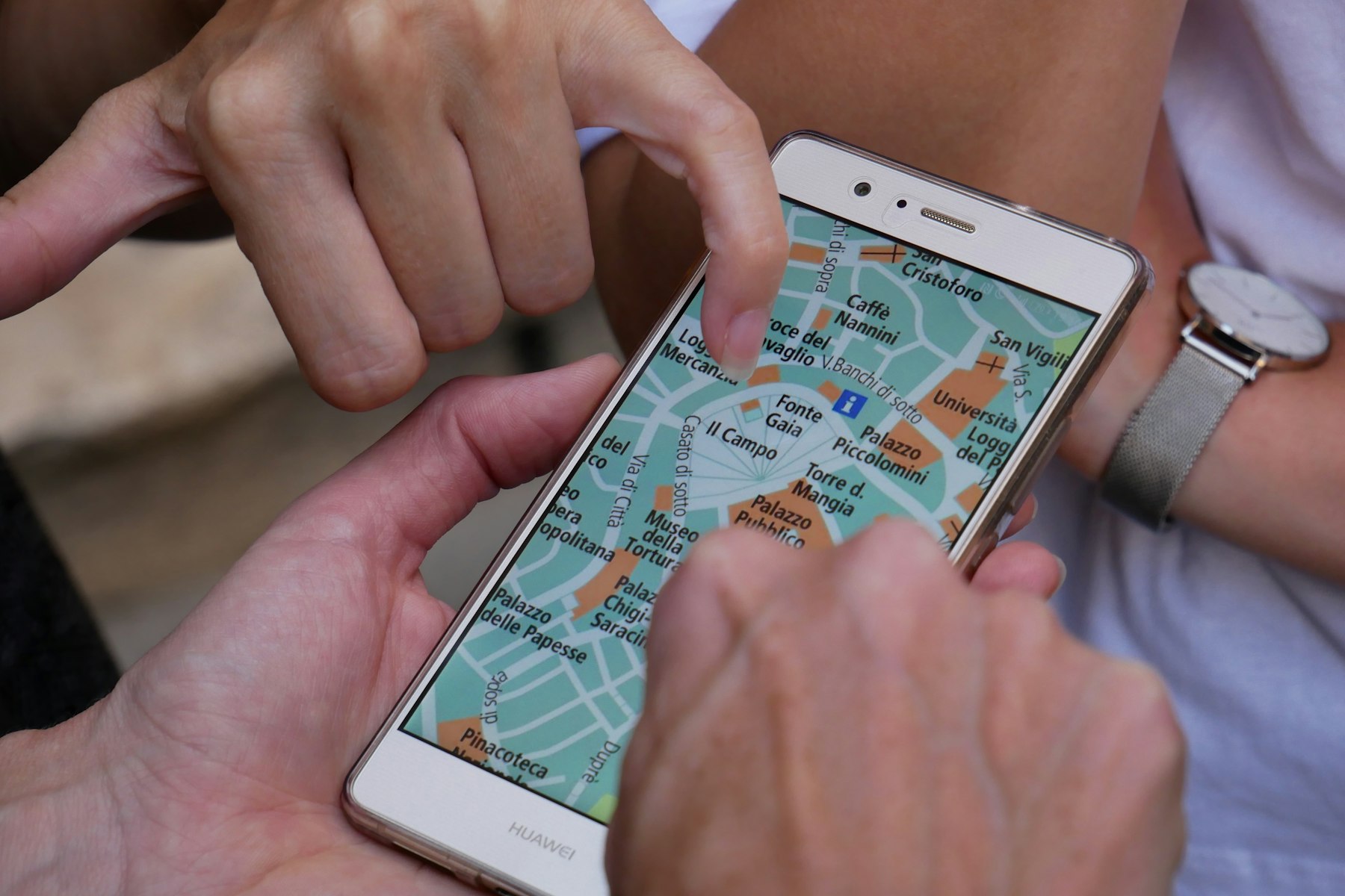 Two people looking at a map application on a smartphone