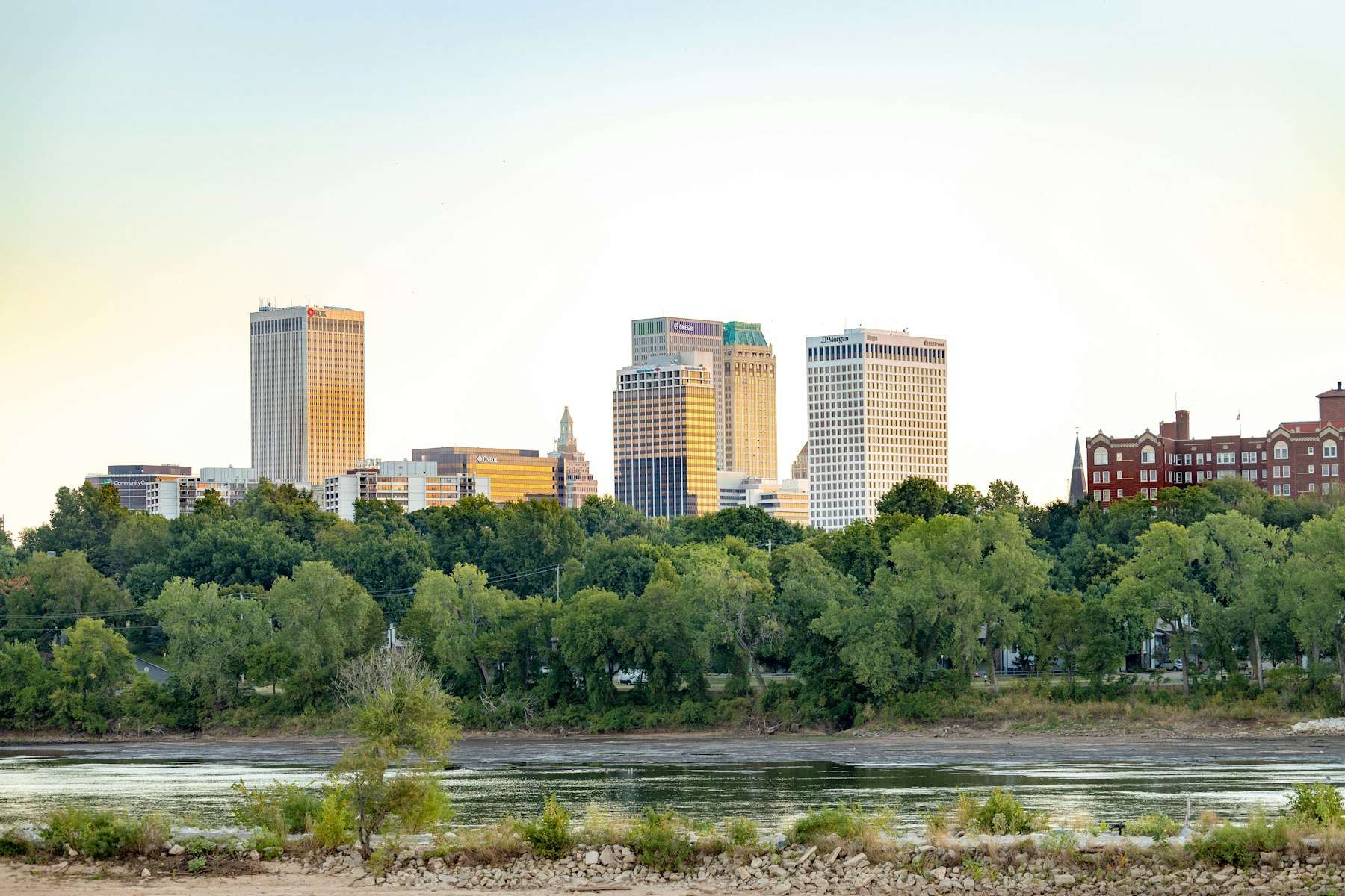 Downtown Tulsa skyline at golden hour, viewed across the Arkansas River