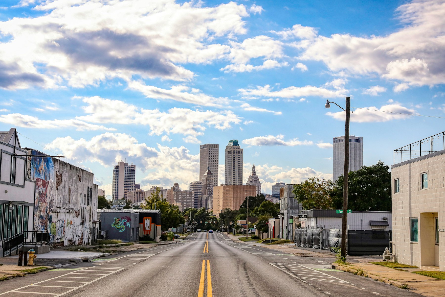 A downtown Tulsa street leading toward the city skyline