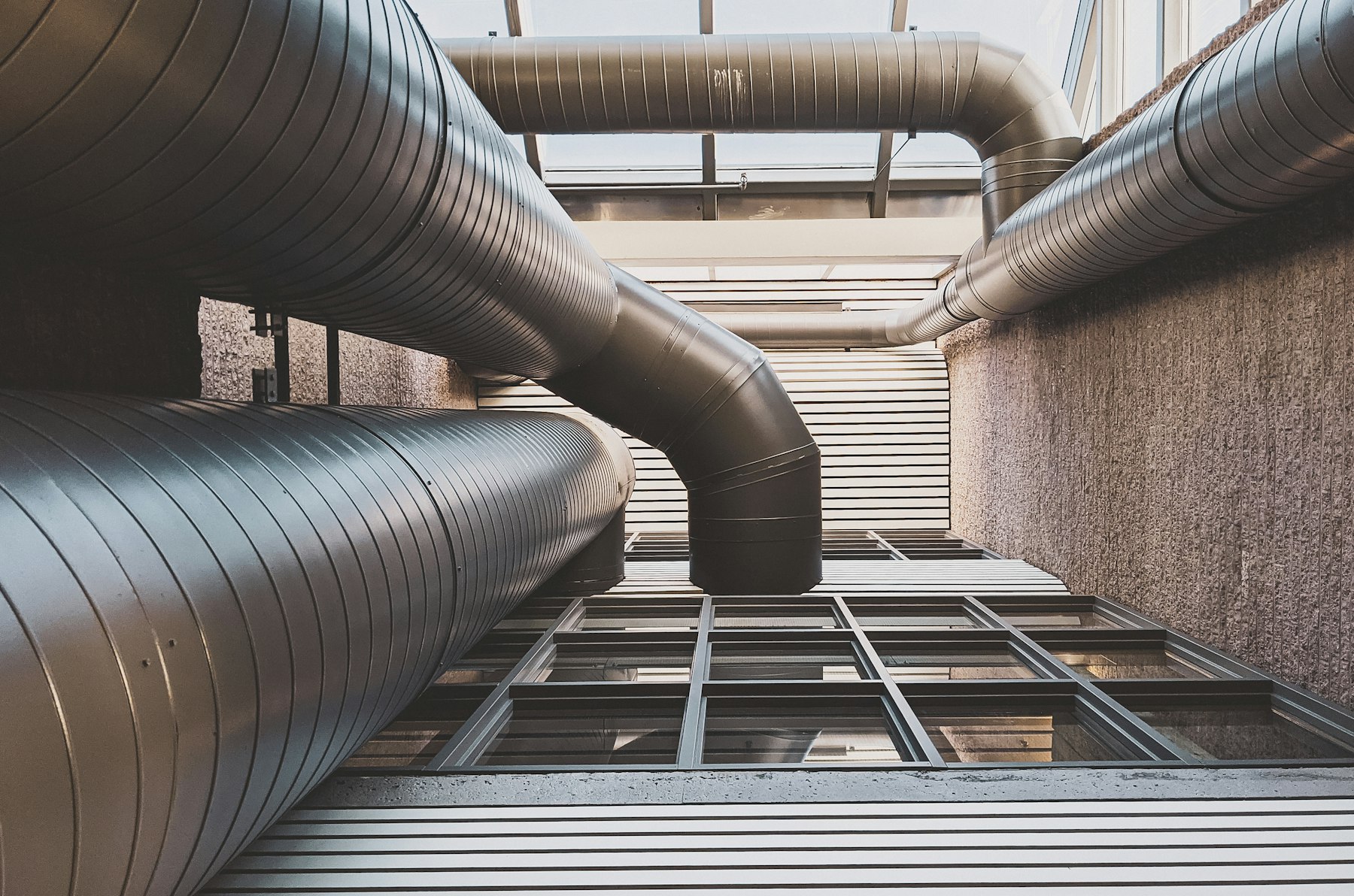 Rooftop HVAC ductwork and vent stacks viewed from below